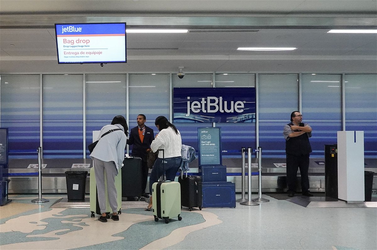 <i>Joe Raedle/Getty Images via CNN Newsource</i><br/>Customers check in their bags at a JetBlue counter in the Fort Lauderdale-Hollywood International Airport in January.