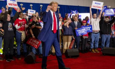 Republican presidential candidate former President Donald Trump takes to the stage before speaking on April 2