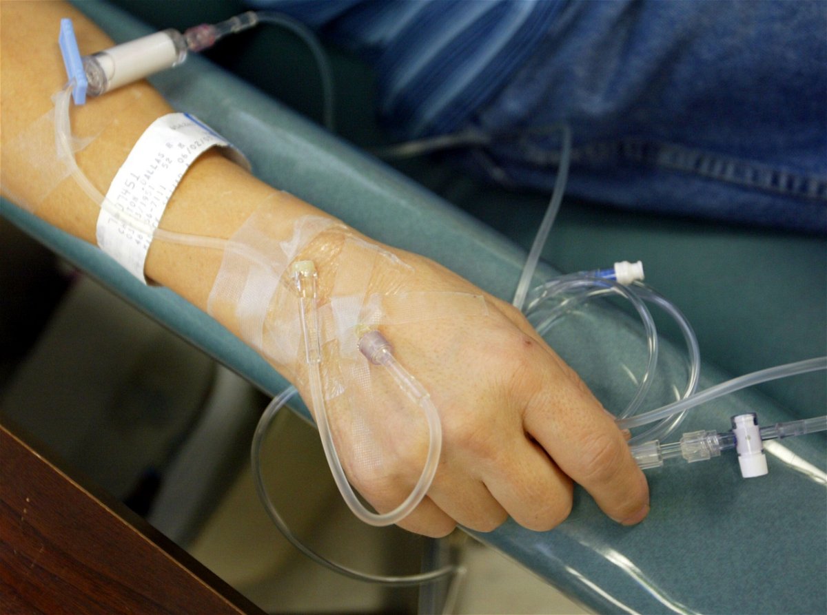 <i>Chris Hondros/Getty Images/File via CNN Newsource</i><br/>A cancer patient holds the IV tubes during chemotherapy.