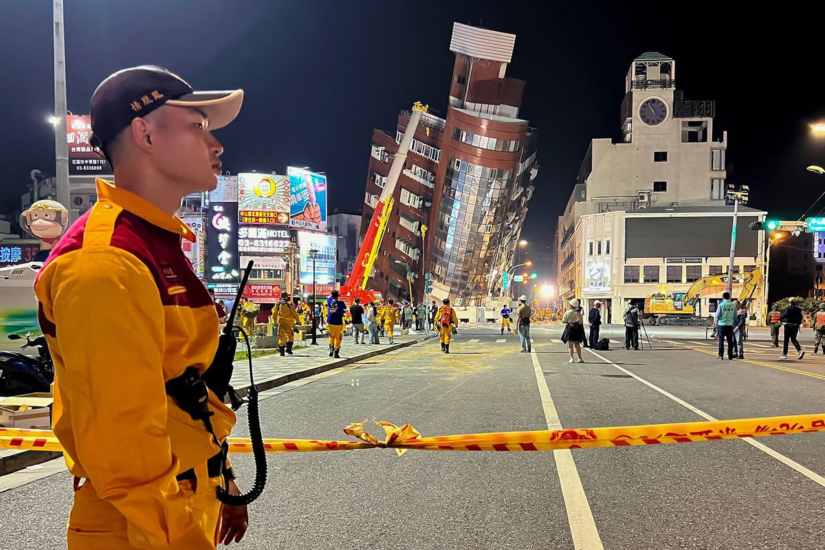 <i>Johnson Lai/AP via CNN Newsource</i><br/>A rescue worker stands near the cordoned off site in the aftermath of an earthquake in Hualien