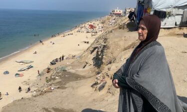 Palestinians help an elderly woman