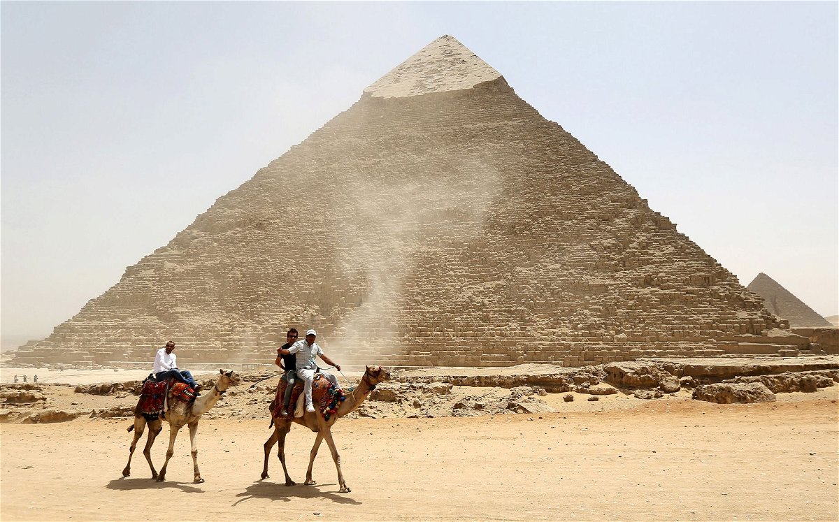 <i>Mohamed Abd El Ghany/Reuters via CNN Newsource</i><br/>Tourists ride on camels next to the Pyramid of Khufu on the Great Pyramids of Giza