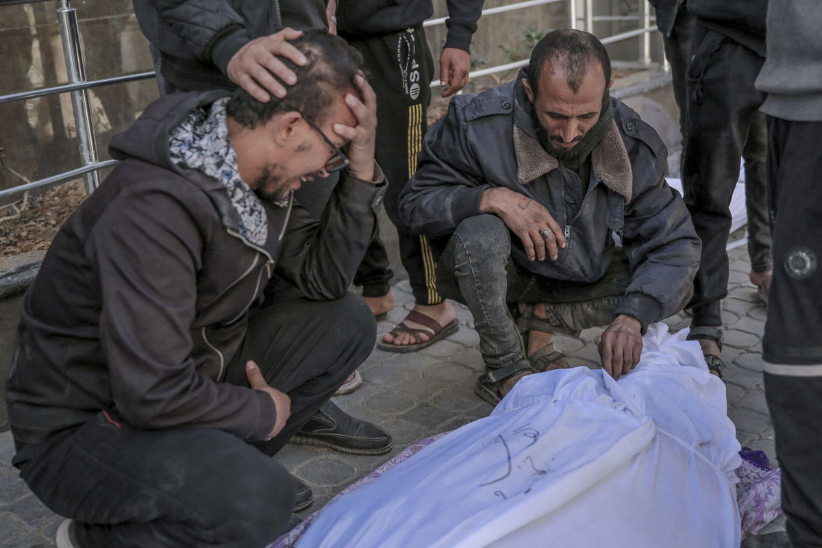 <i>AFP/Getty Images via CNN Newsource</i><br/>People mourn outside Al-Shifa hospital in Gaza City over one of the Palestinians killed during the aid delivery on February 29.