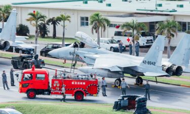 Aircraft tugs pulled the fighter jets on to a road at Naha Air Base on Okinawa to be sure they were not damaged in a possible tsunami.