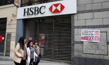 Pedestrians walk past a closed HSBC branch during a national strike in Buenos Aires