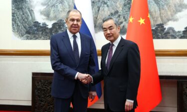 Russia's Foreign Minister Sergey Lavrov shakes hands with China's Foreign Minister Wang Yi during a meeting in Beijing on April 9.