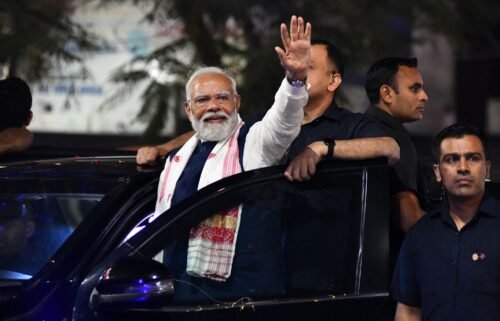 Indian Prime Minister and leader of the ruling Bharatiya Janata Party Narendra Modi waves to supporters at an election campaign event in Guwahati on April 16