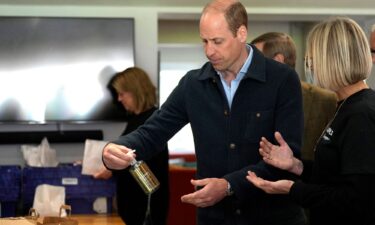 The prince is shown items by charity operations director Claire Hopkins during the engagement at the surplus food redistribution charity.