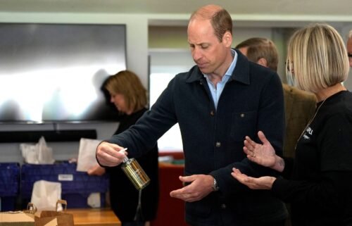The prince is shown items by charity operations director Claire Hopkins during the engagement at the surplus food redistribution charity.