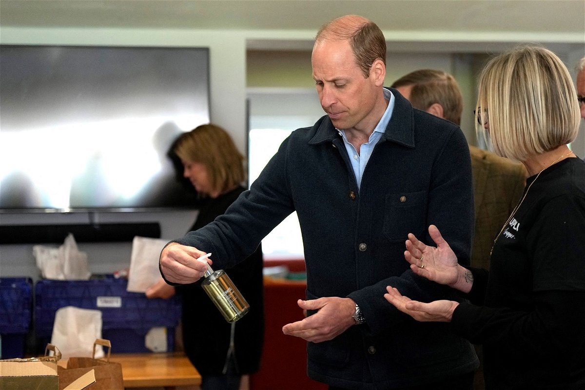 <i>Alastair Grant/Reuters via CNN Newsource</i><br/>The prince is shown items by charity operations director Claire Hopkins during the engagement at the surplus food redistribution charity.