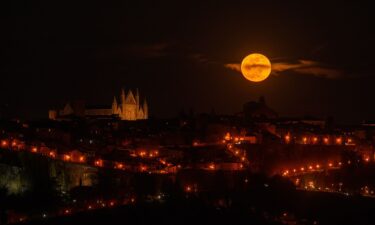 The pink moon rises next to Orvieto Cathedral in the region of Umbria in Italy