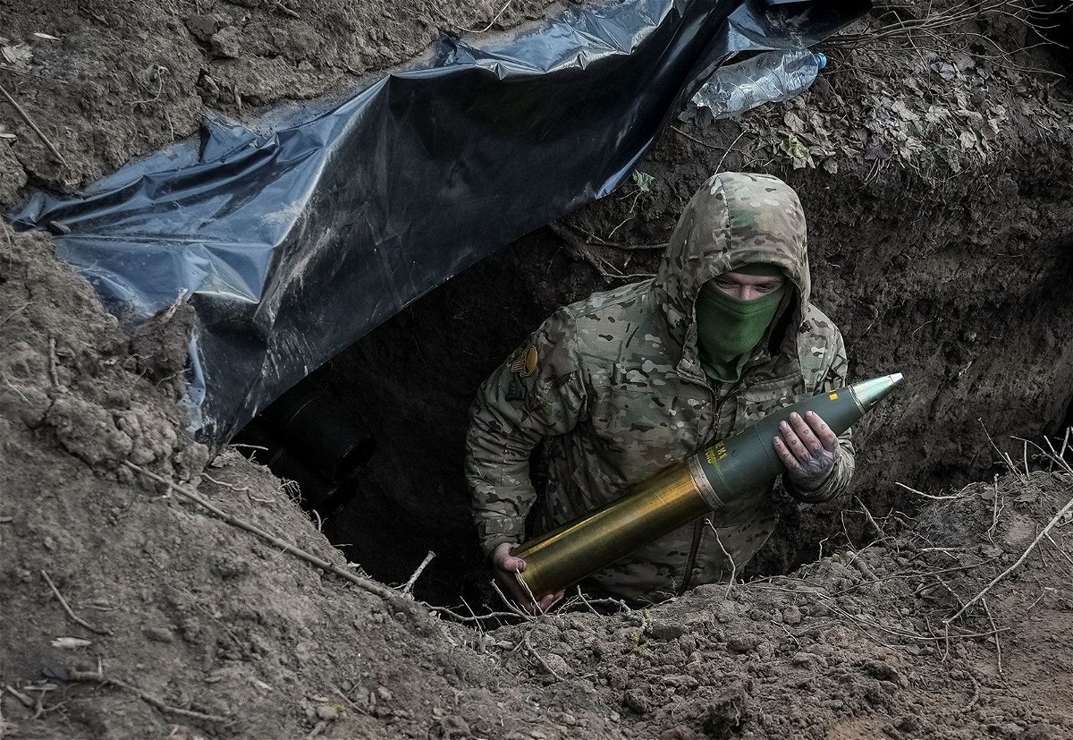 <i>Inna Varenytsia/Reuters via CNN Newsource</i><br/>A Ukrainian soldier holds an artillery shell as he prepares to fire a howitzer towards Russian troops near the town of Kreminna