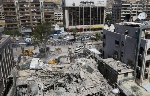 Rescue workers search in the rubble of a destroyed Iranian consulate building in Damascus on April 2 following a suspected Israeli airstrike.