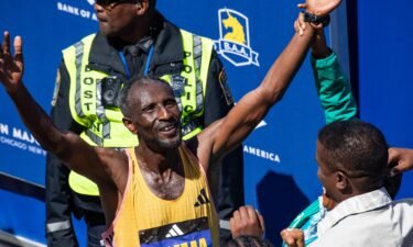 Sisay Lemma celebrates winning the men's event at the 128th Boston Marathon.