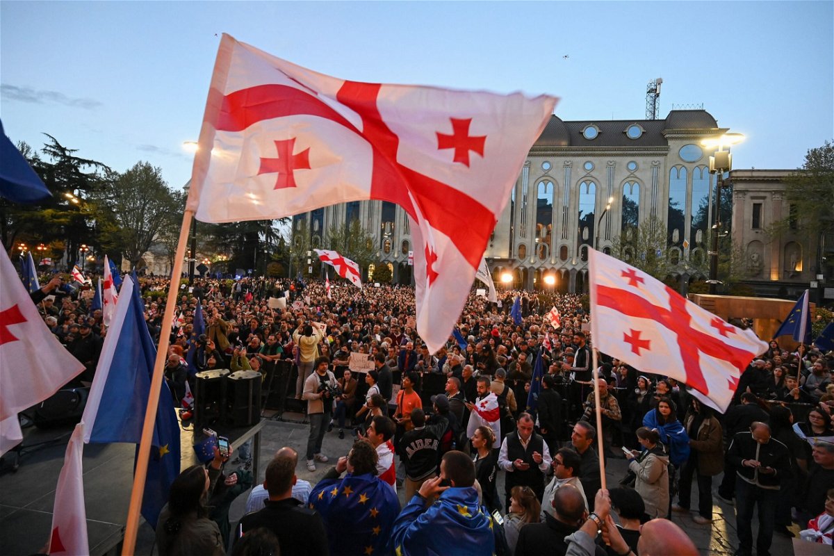 <i>Vano Shlamov/AFP/Getty Images via CNN Newsource</i><br/>Georgian pro-democracy activists wave Georgia and European Union flags as they protest against a 