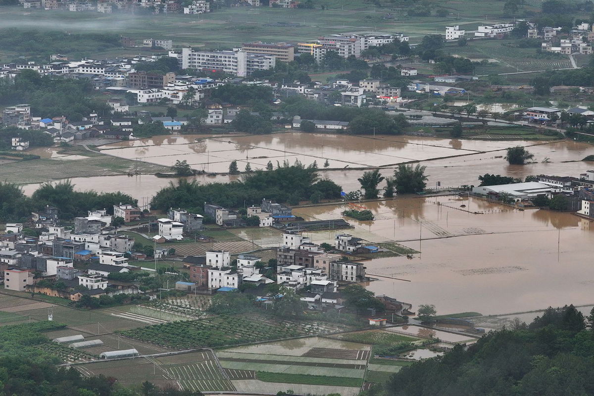 <i>VCG/Visual China Group/Getty Images via CNN Newsource</i><br/>Village roads and farmlands are submerged in water after heavy rains in Qingyuan city