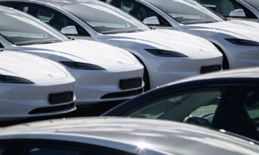 Rows of new Tesla cars are seen in a holding area near a customer collection point in London
