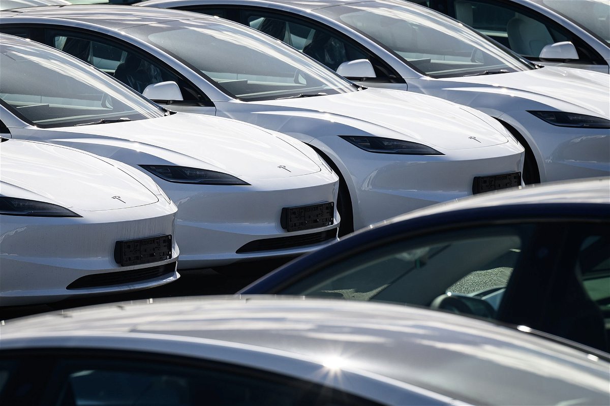<i>Leon Neal/Getty Images via CNN Newsource</i><br/>Rows of new Tesla cars are seen in a holding area near a customer collection point in London