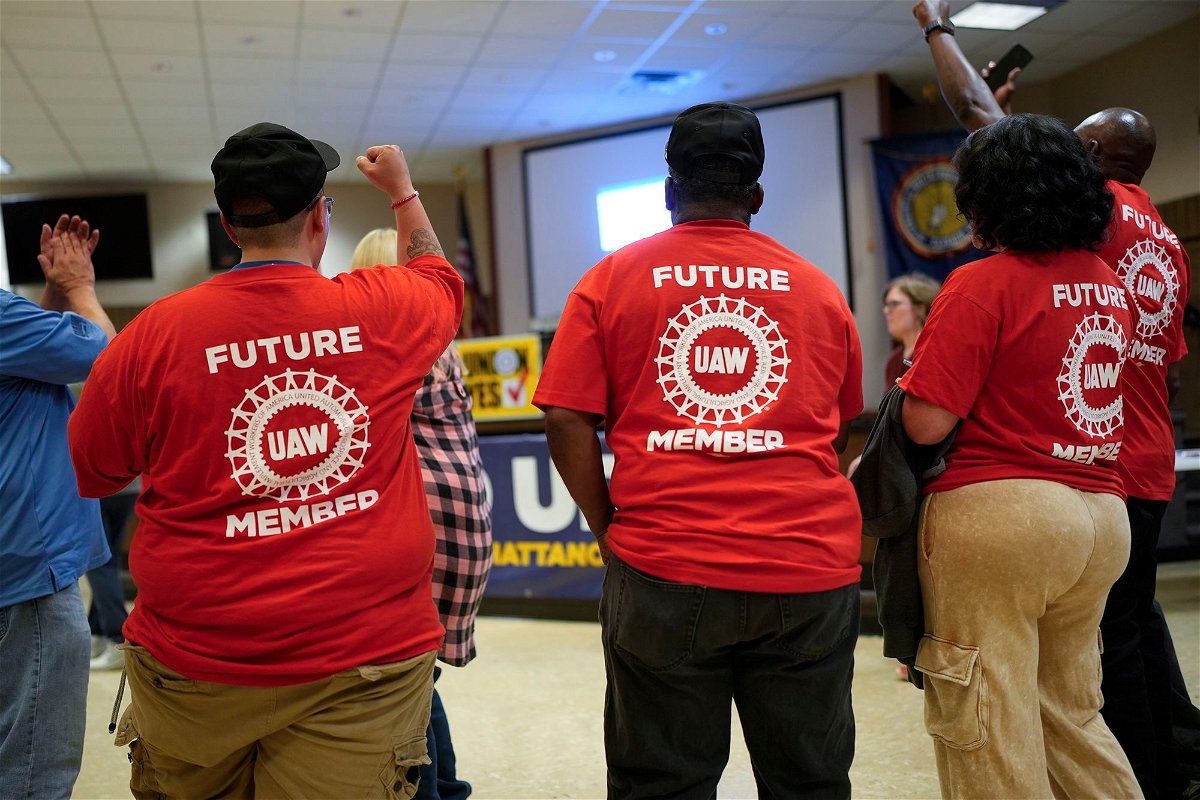 Volkswagen automobile plant employees celebrate winning a vote to join the UAW union Friday
