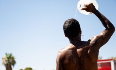 A person cools off amid searing heat in Phoenix