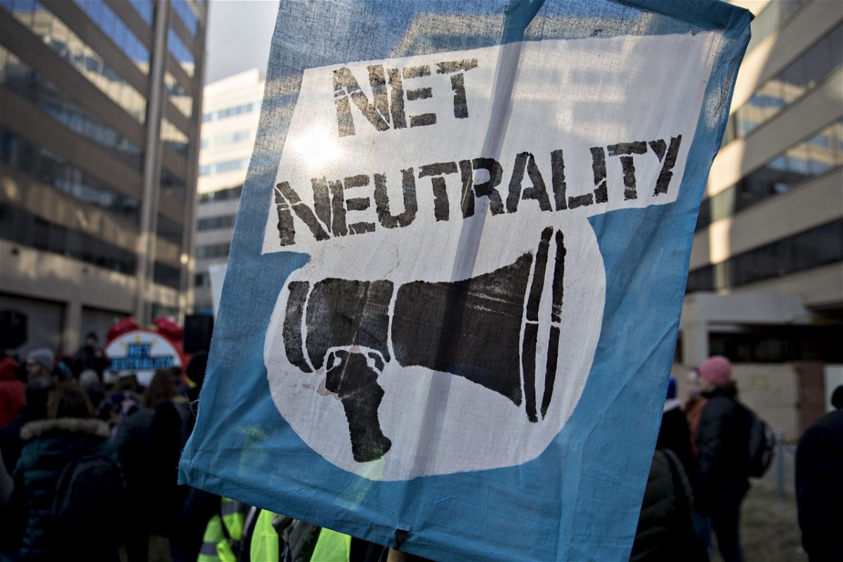 A demonstrator opposed to the roll back of net neutrality rules holds a sign outside the Federal Communications Commission (FCC) headquarters in Washington