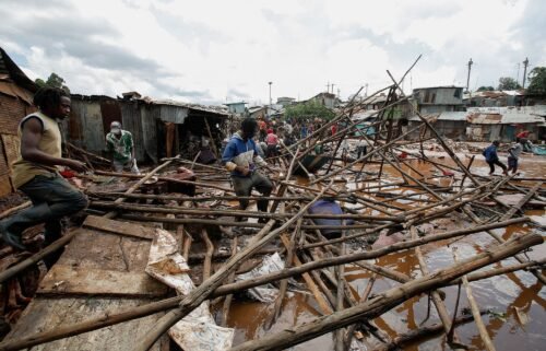 Residents sift through the rubble as they recover their belongings after the Nairobi river burst its banks and destroyed their homes within the Mathare Valley settlement in Nairobi