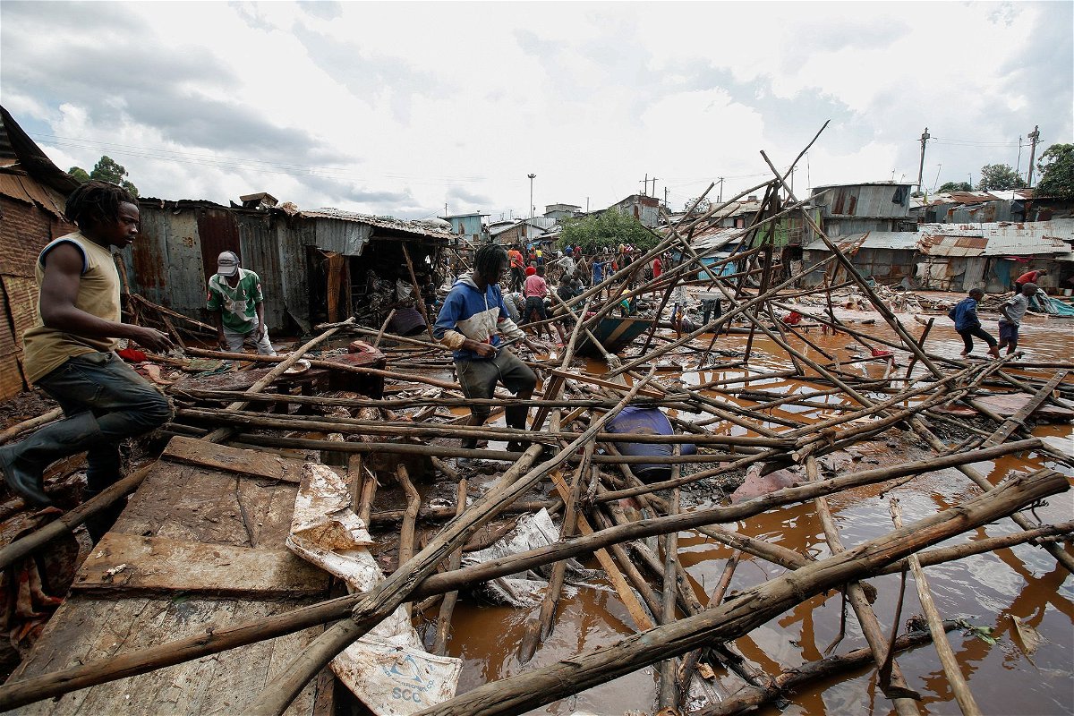 Residents sift through the rubble as they recover their belongings after the Nairobi river burst its banks and destroyed their homes within the Mathare Valley settlement in Nairobi