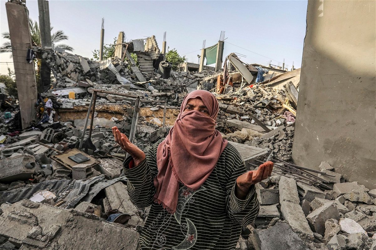 <i>Abed Rahim Khatib/picture-alliance/dpa/AP via CNN Newsource</i><br/>A Palestinian woman inspects a house that was destroyed by an Israeli bombing in Rafah