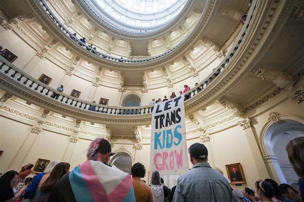 <i>Mikala Compton/American-Statesman/USA Today Network via CNN Newsource</i><br/>Equality Texas leadership drops a banner in the Capitol rotunda as LGBTQ rights activists protest SB14 at the Capitol of Texas in May 2023. The state of Texas is suing the Biden administration over recently announced federal protections for LGBTQ+ students.