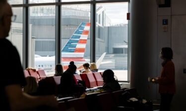 Passengers wait to board an American Airlines flight at LaGuardia Airport in New York City in April.