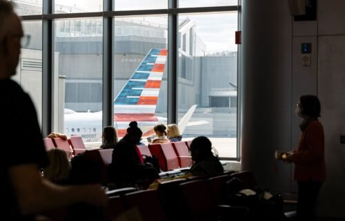 Passengers wait to board an American Airlines flight at LaGuardia Airport in New York City in April.