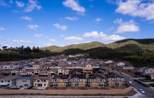 A drone view shows single-family homes at a new subdivision under construction in the rural hills of San Marcos