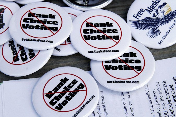 Campaign buttons urging Alaskans to repeal ranked choice voting in Alaska sit on a picnic table at the home of Phil Izon, a backer of the initiative, in Wasilla, Alaska, on Tuesday, May 14.