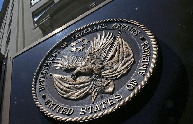 A seal is displayed on the front of the Veterans Affairs Department building in Washington in June 2013. A US military veteran who admitted he faked being unable to walk while claiming disability benefits has been sentenced to prison time.