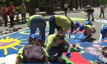 Labor groups painted the street in unpermitted protest at the California State Capitol on May Day.