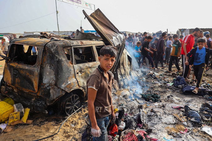Palestinians gather at the site of an Israeli strike on a displacement camp in Rafah, on May 27.