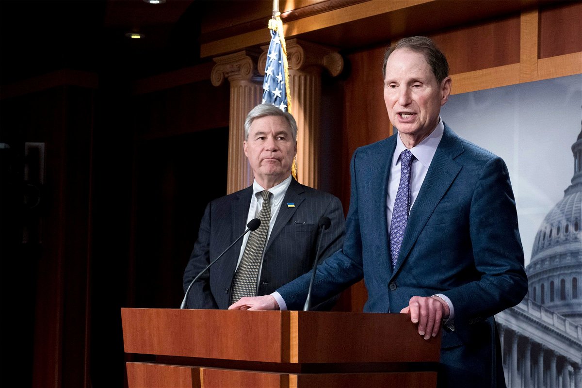 In this March 2023 photo, Senate Budget Committee Chairman Sheldon Whitehouse, left, and Senate Finance Committee Chairman Ron Wyden talk to reporters in Washington, DC.