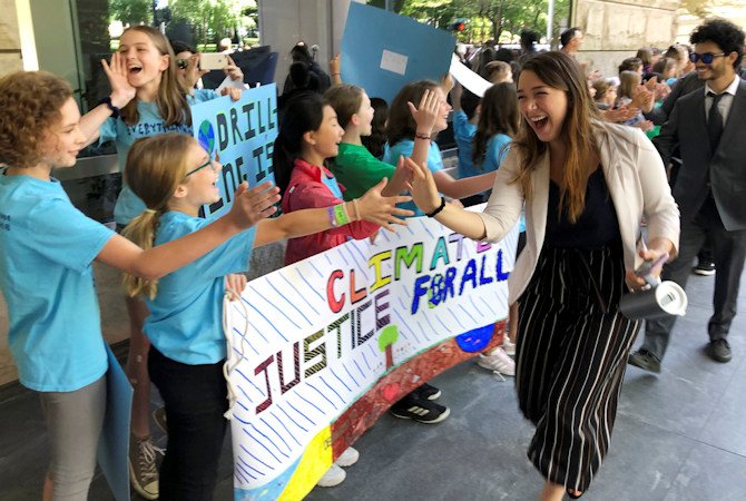  Kelsey Juliana, of Eugene, Ore., a lead plaintiff who is part of a lawsuit by a group of young people who say U.S. energy policies are causing climate change and hurting their future, greets supporters outside a federal courthouse, June 4, 2019, in Portland.