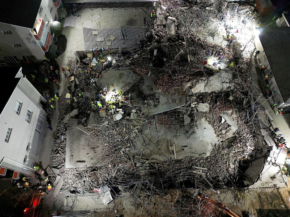 <i>Shafiek Tassiem/Reuters via CNN Newsource</i><br/>A drone view of the scene of a building collapse where several construction workers are thought to be trapped in George