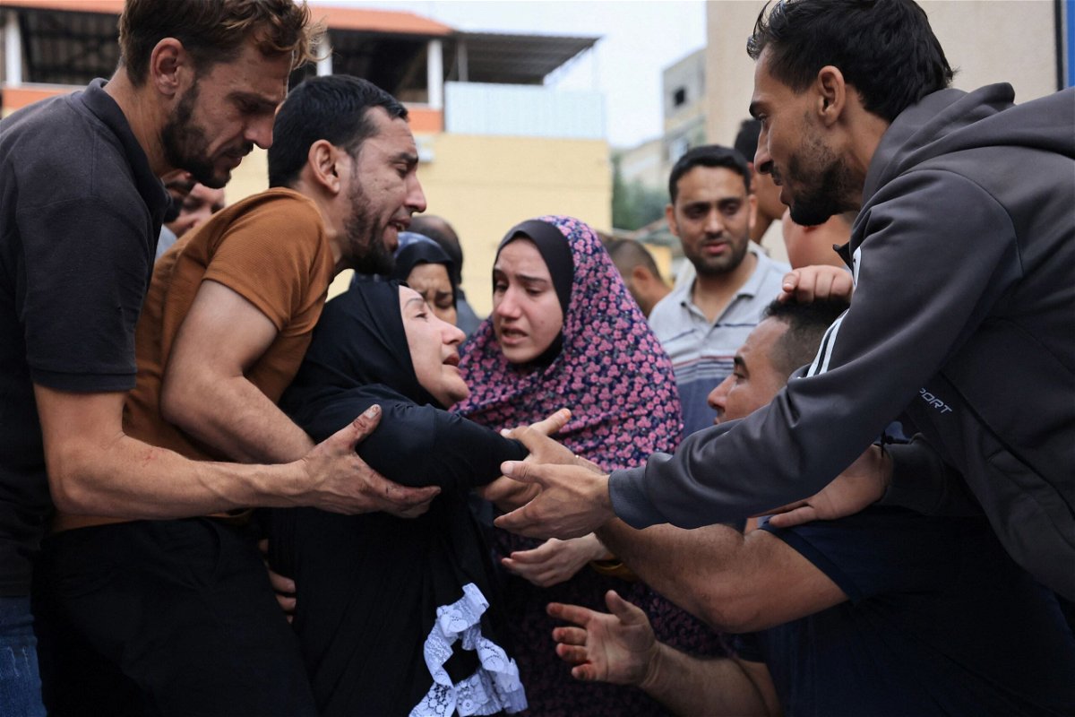<i>Mahmud Hams/AFP via Getty Images via CNN Newsource</i><br/>Palestinians mourn the death of their relatives following an Israeli airstrike on the refugee camp of Jabalia in the Gaza Strip in October 2023.