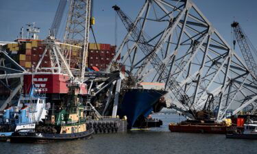 The cargo ship Dali is seen stuck in the remains of the Key Bridge as workers remove debris at the Patapsco River entrance to Baltimore Harbor on May 2