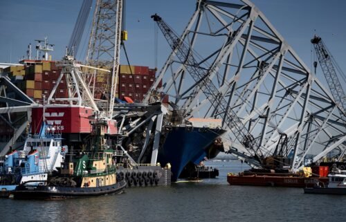The cargo ship Dali is seen stuck in the remains of the Key Bridge as workers remove debris at the Patapsco River entrance to Baltimore Harbor on May 2