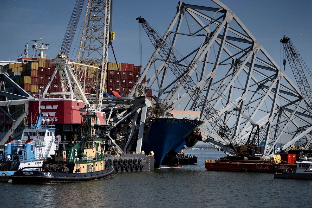 <i>Brendan Smialowski/AFP/Getty Images via CNN Newsource</i><br/>The cargo ship Dali is seen stuck in the remains of the Key Bridge as workers remove debris at the Patapsco River entrance to Baltimore Harbor on May 2