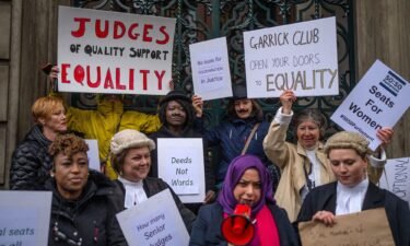 Protesters are pictured outside the Garrick Club on March 28.