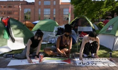 Activists make protest signs inside a pro-Palestinian encampment at George Washington University in Washington