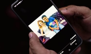 Jameel Shah shows a photo of himself with Australian actor and singer Kylie Minogue in Mumbai on April 14.