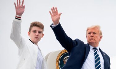 President Donald Trump and his son Barron wave as they board Air Force One in August 2020. Barron was selected by the Florida GOP as an at-large delegate for Florida at the Republican National Convention.