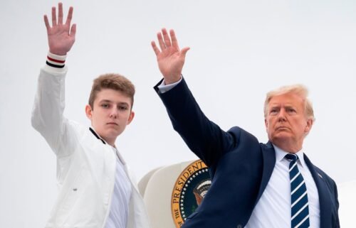 President Donald Trump and his son Barron wave as they board Air Force One in August 2020. Barron was selected by the Florida GOP as an at-large delegate for Florida at the Republican National Convention.