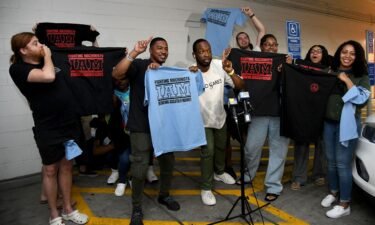 Workers at the Towson Town Center Apple hold their new union T-shirts after their store employees decided to join the International Association of Machinists Union. Theirs is the first Apple store in the US to vote for union representation.