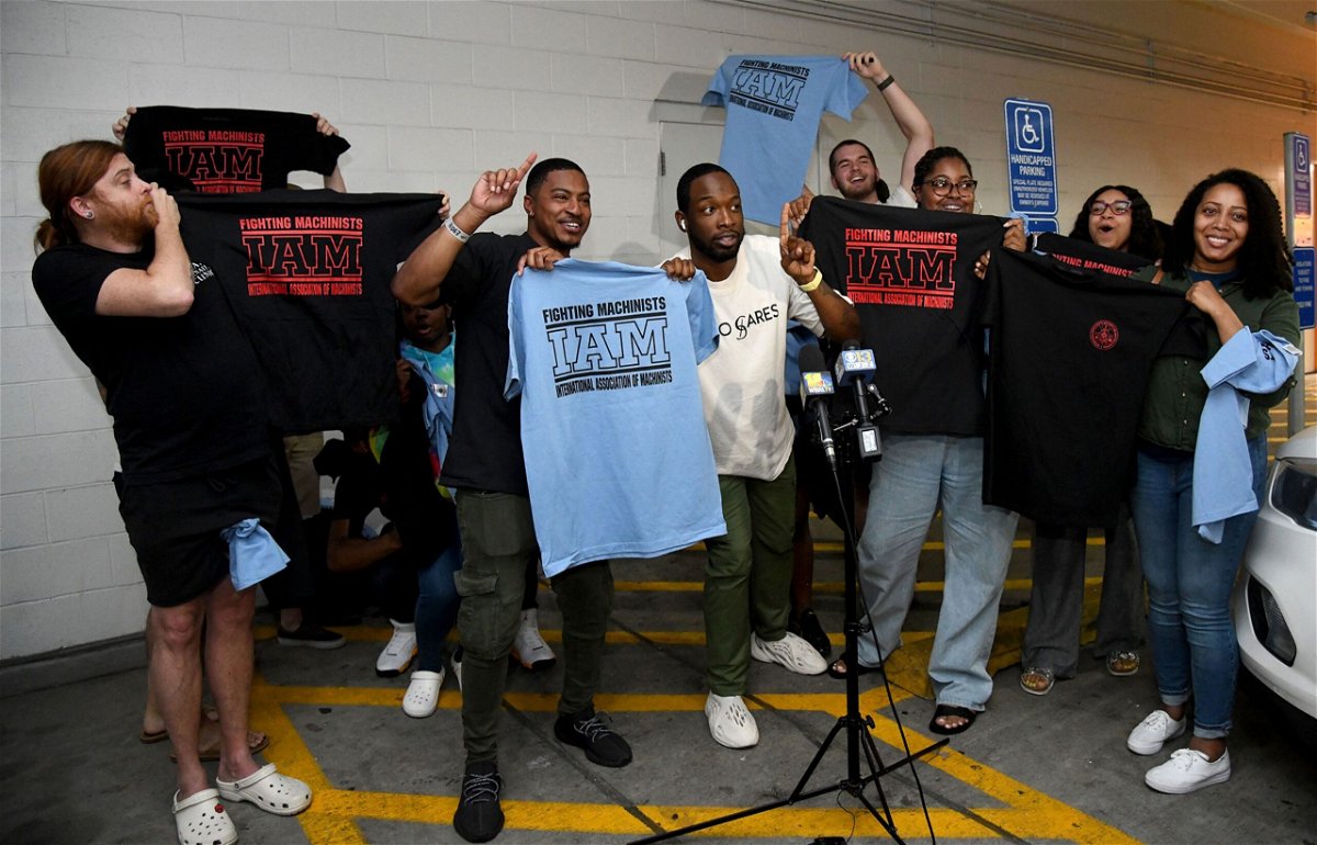 <i>Barbara Haddock Taylor/The Baltimore Sun/Tribune News Service/Getty Images via CNN Newsource</i><br/>Workers at the Towson Town Center Apple hold their new union T-shirts after their store employees decided to join the International Association of Machinists Union. Theirs is the first Apple store in the US to vote for union representation.